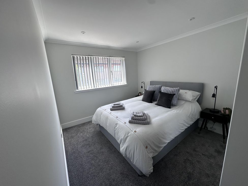 A bedroom with a bed and bedside table at 22 Fraser Avenue