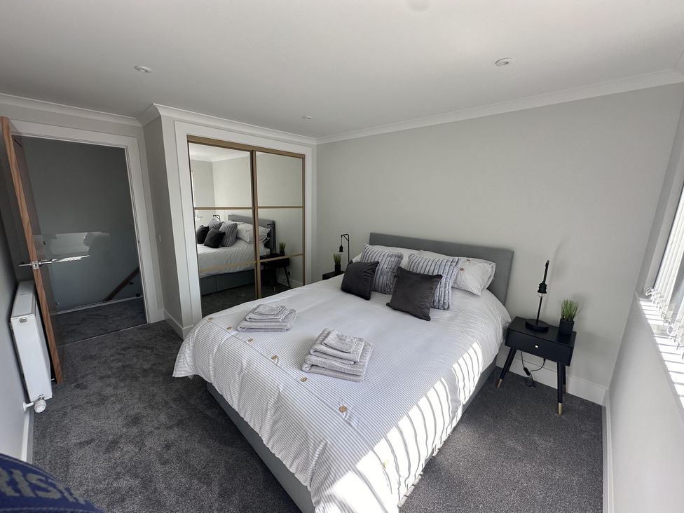 A bedroom with a bed and nightstand at 22 Fraser Avenue 