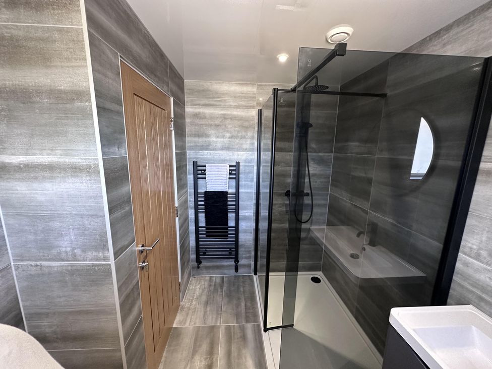 A bathroom with a shower and bathtub at 22 Fraser Avenue