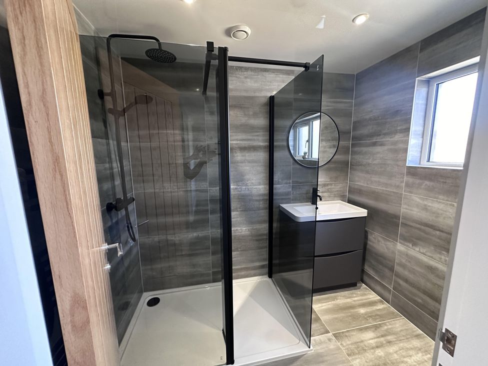 A bathroom with a shower and sink at 22 Fraser Avenue