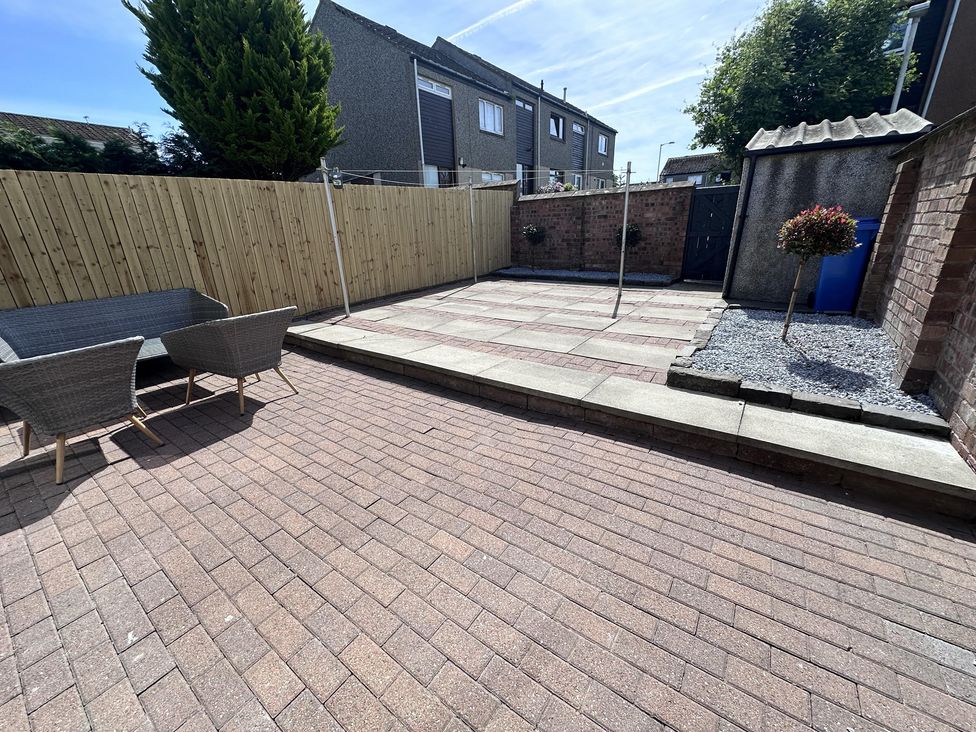A garden with patio and seating area at 22 Fraser Avenue