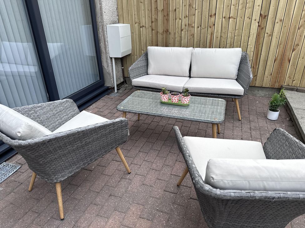 A seating area with a sofa and armchairs at 22 Fraser Avenue