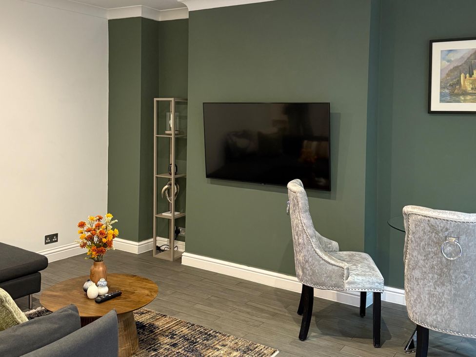 A living room with a television and a coffee table at Seaside Bliss in Brighton