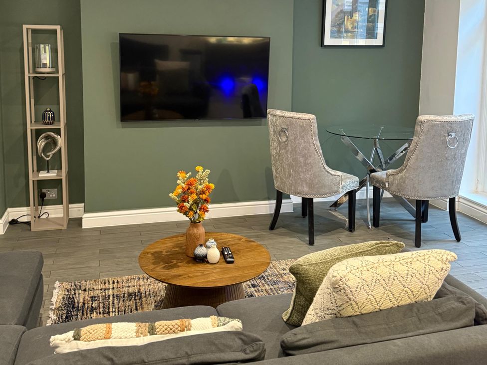 A living room with a sofa and a coffee table at Seaside Bliss in Brighton