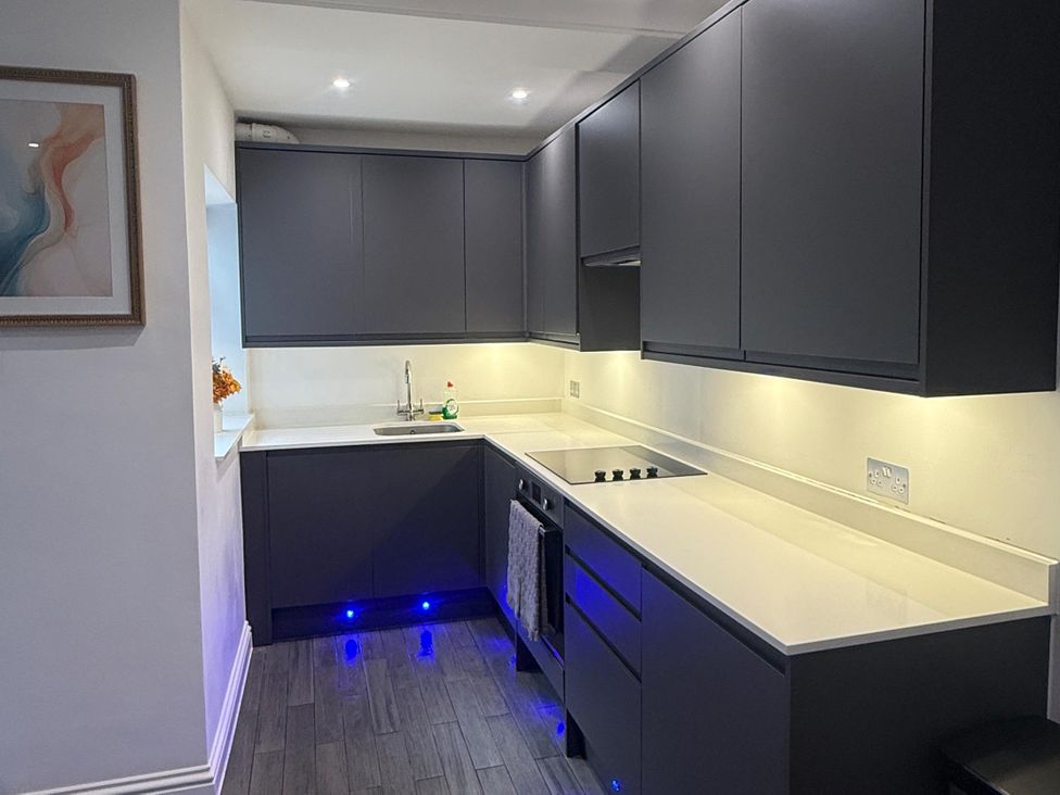 A kitchen with cabinets, countertop, sink and oven at Seaside Bliss in Brighton