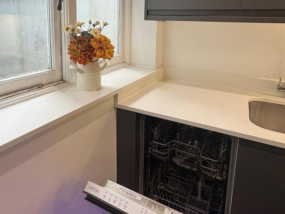 A kitchen with a sink and dishwasher at Seaside Bliss in Brighton