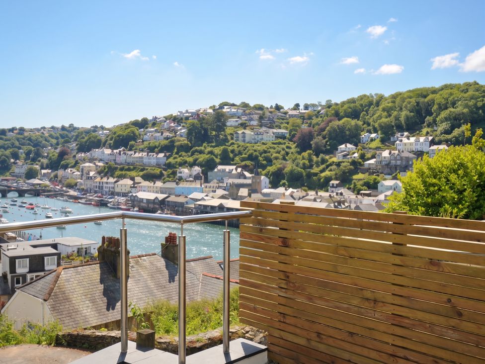 A view of houses on a hill overlooking water at Barton House in Looe