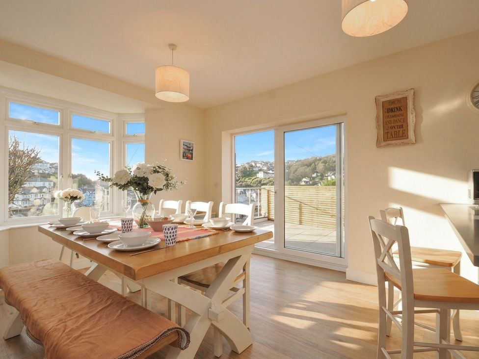 A dining room with a table and chairs at Barton House in Looe