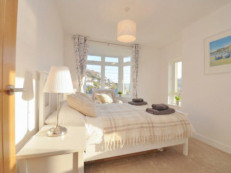 A bedroom with a bed and lamp at Barton House in Looe