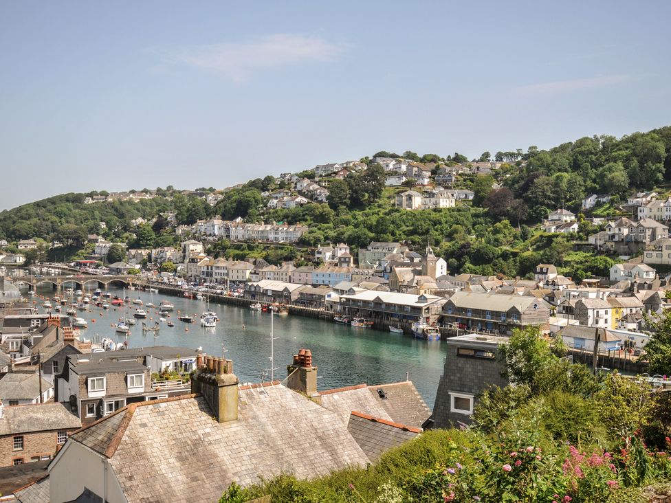 A view of a harbor with boats and buildings at Barton House in Looe