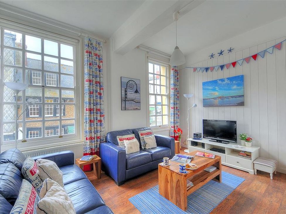 A living room with a sofa and coffee table at 1 The Old Posthouse in Lyme Regis