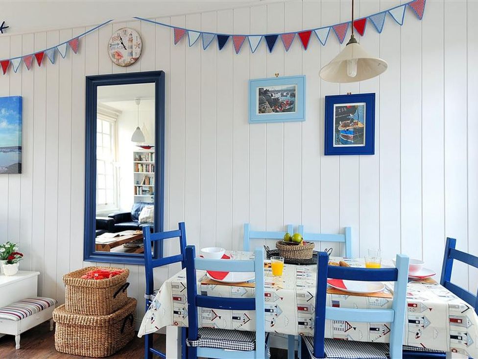 A dining room with a table and chairs at 1 The Old Posthouse in Lyme Regis