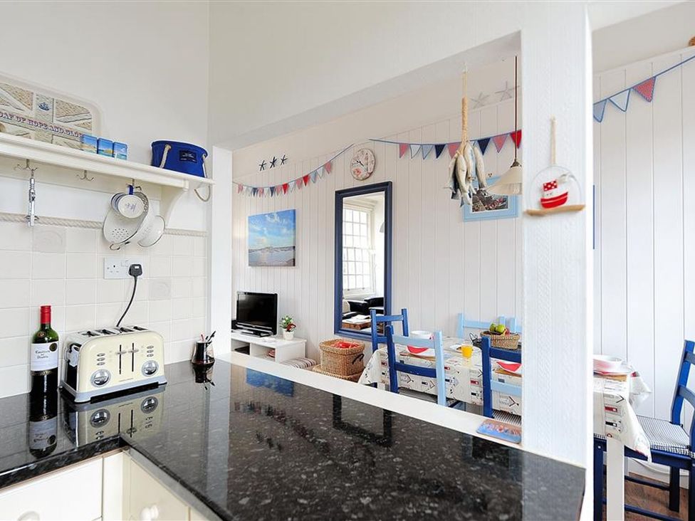A kitchen with a toaster and wine bottle at 1 The Old Posthouse in Lyme Regis