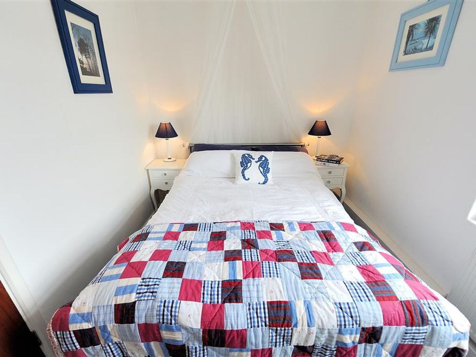 A bedroom with a double bed and bedside tables at 1 The Old Posthouse, Lyme Regis