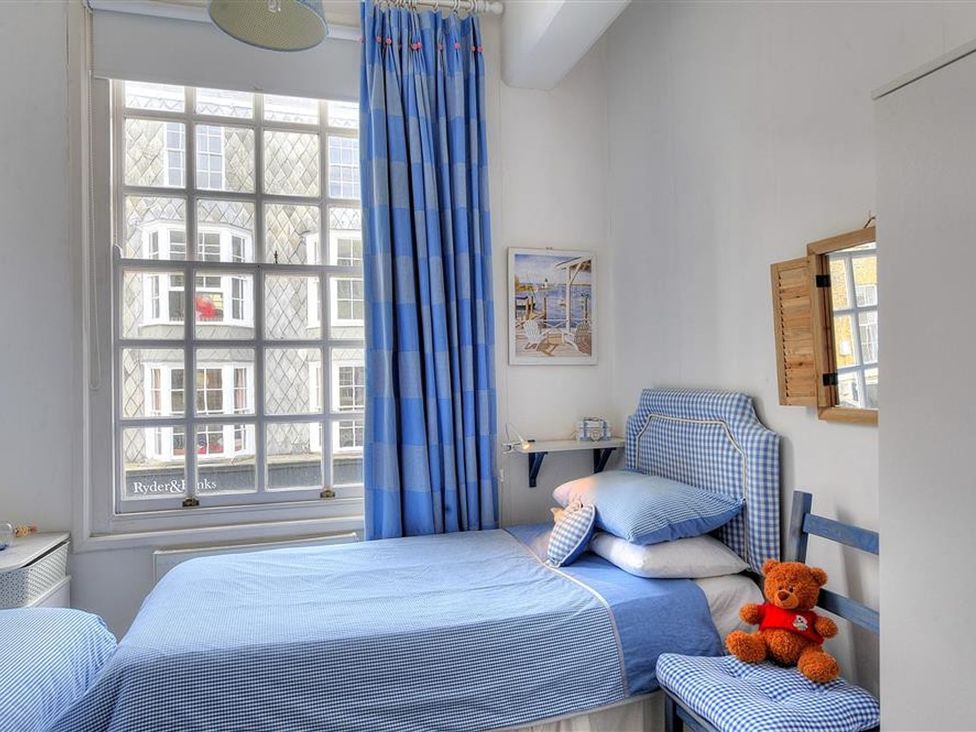 A bedroom with a bed and teddy bear at 1 The Old Posthouse in Lyme Regis