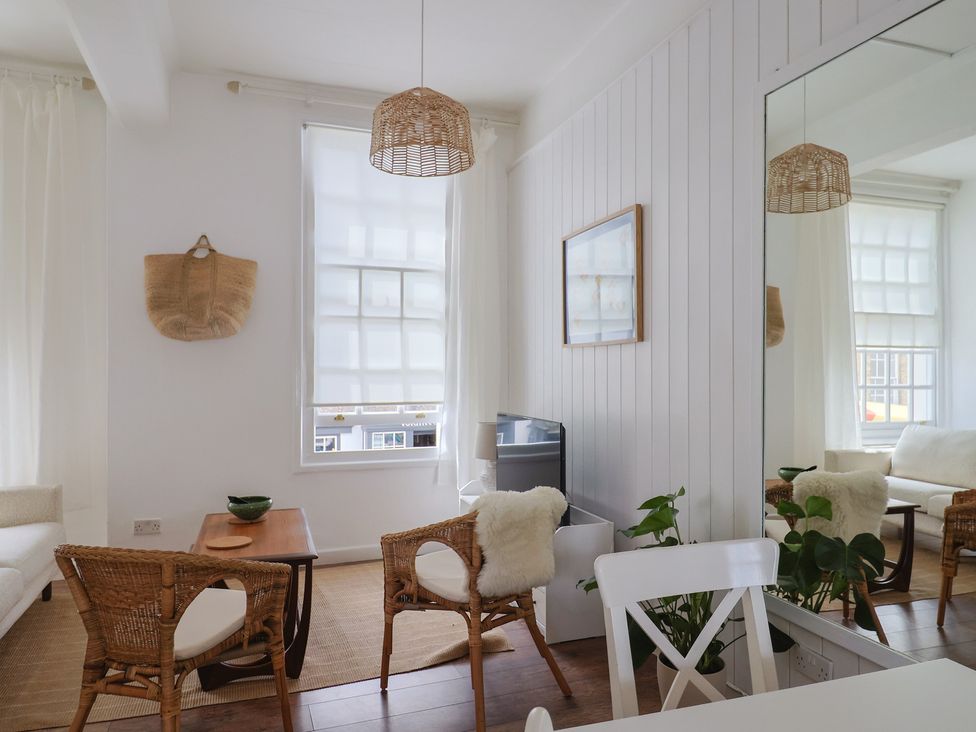A living room with a sofa and chairs at 1 The Old Posthouse in Lyme Regis