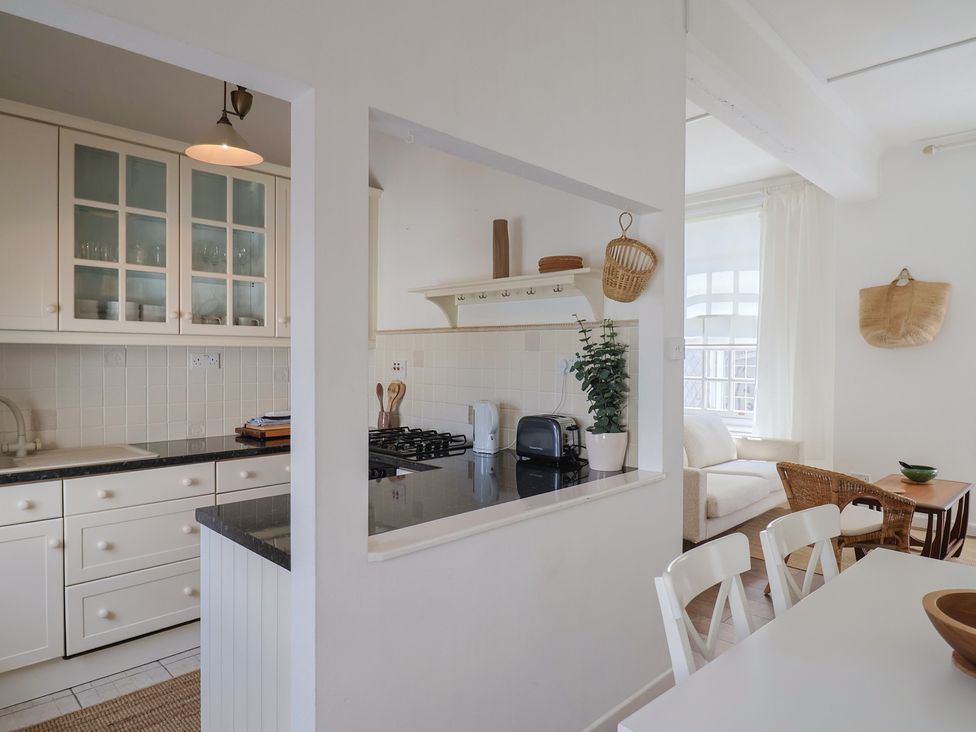 A kitchen with stove and sink at 1 The Old Posthouse in Lyme Regis
