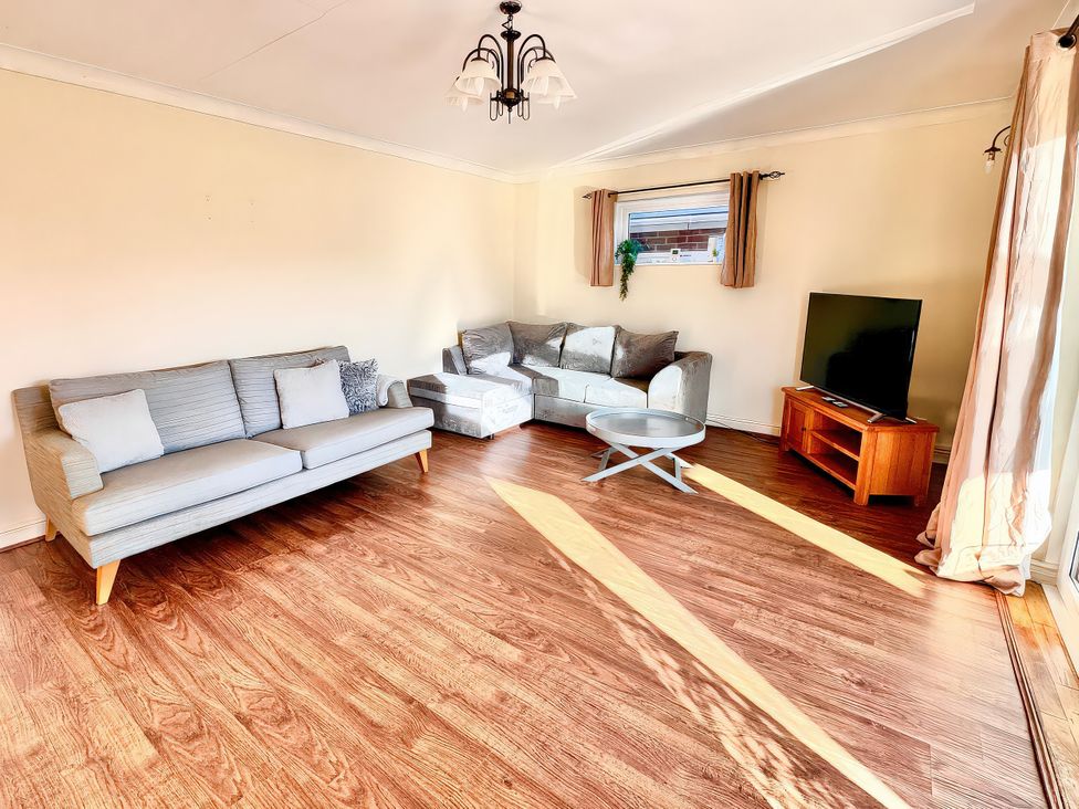 A living room with a sofa and television at 10 Solent View Southampton