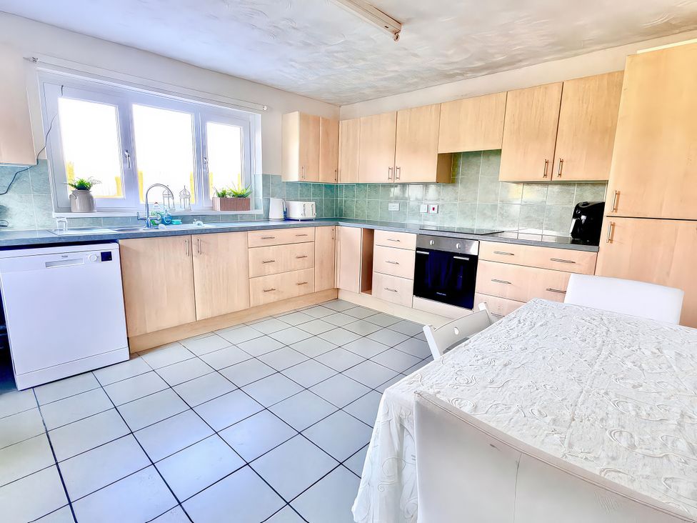 A kitchen with cabinets and appliances at 10 Solent View in Southampton