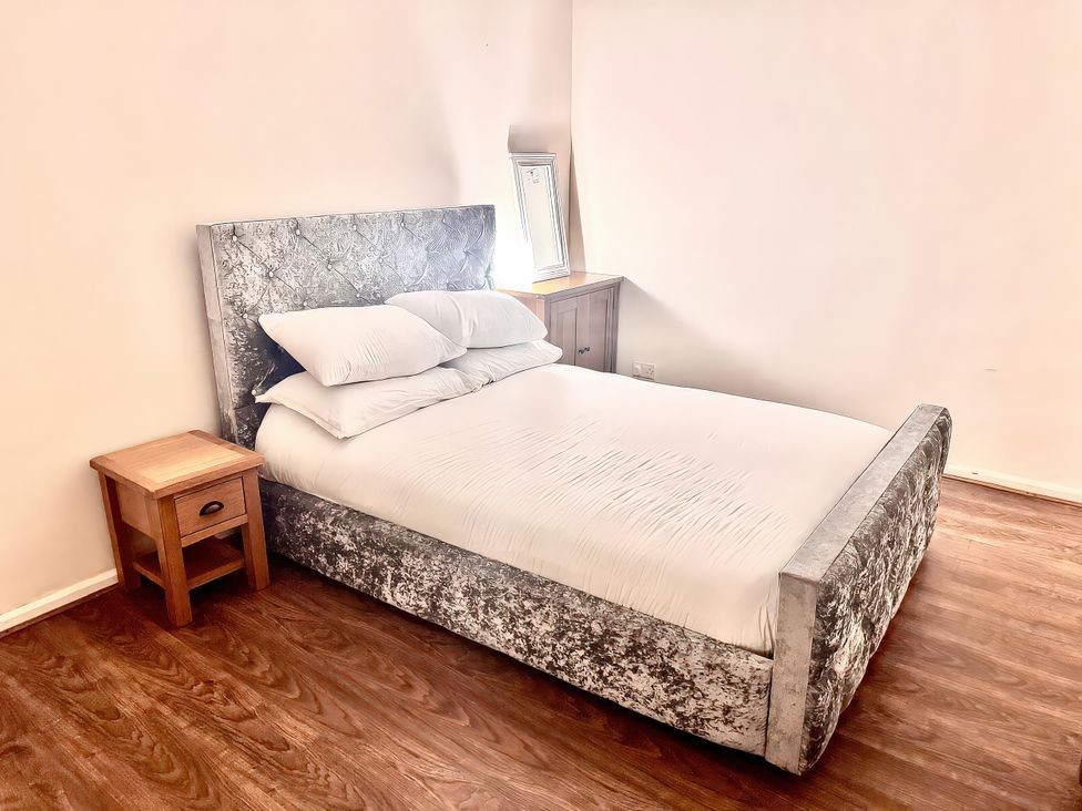 A bedroom with a bed and nightstand at 10 Solent View in Southampton