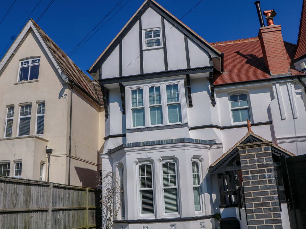 A house with windows and a fence at The Beach House in 