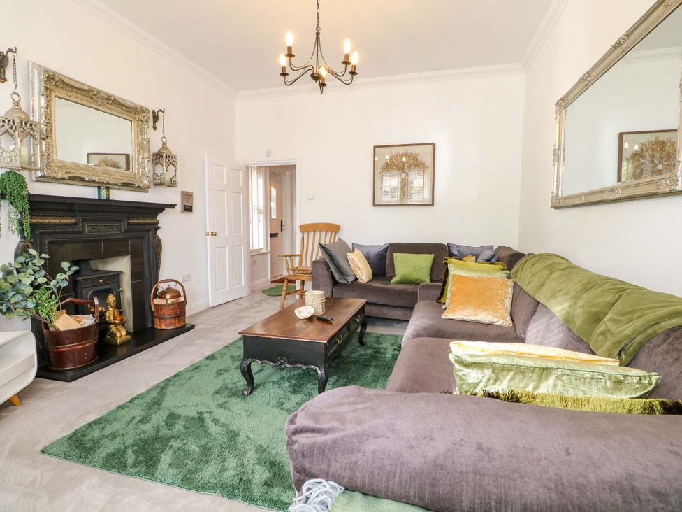 A living room with a fireplace and seating area at The Beach House in Bournemouth
