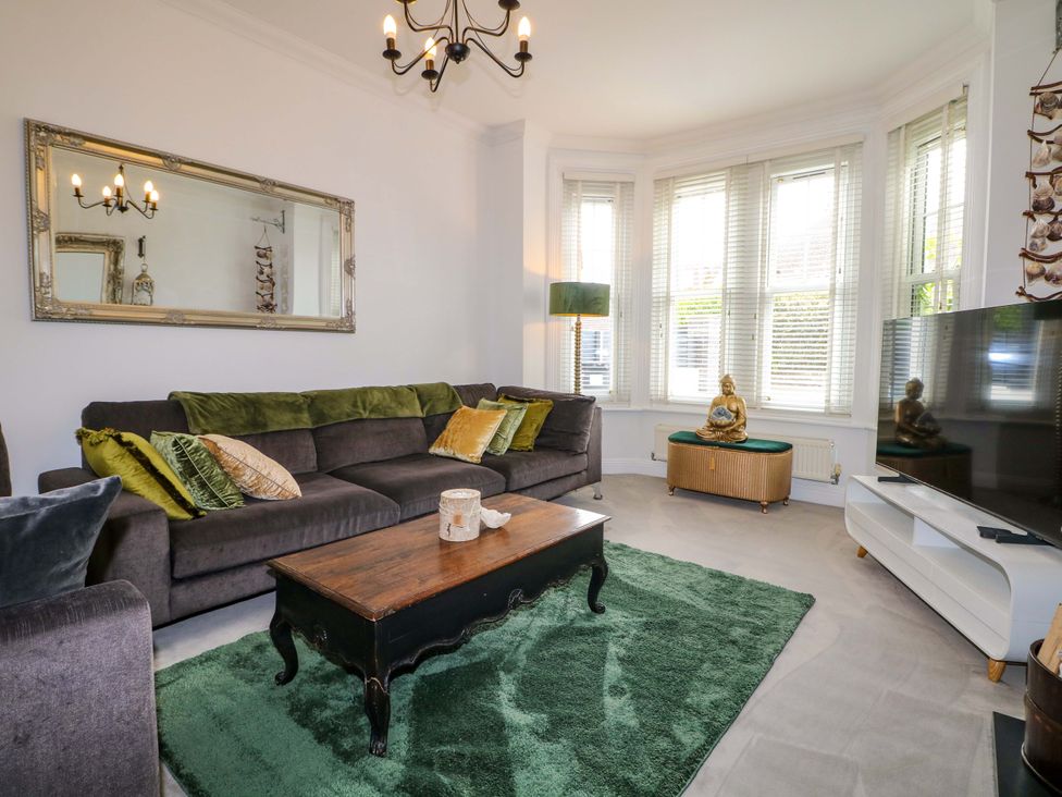 A living room with a sofa and coffee table at The Beach House in Bournemouth