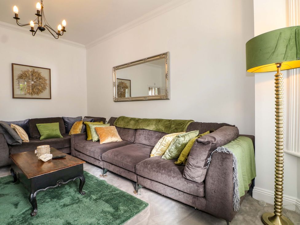 A living room with a sofa and coffee table at The Beach House in Bournemouth
