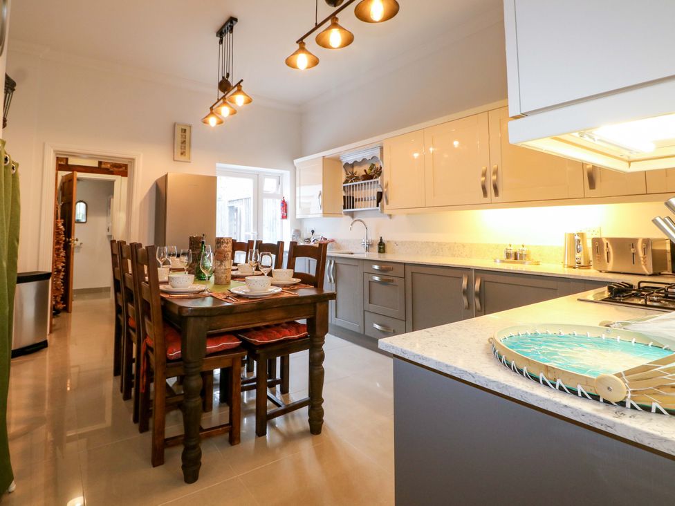A kitchen with a dining table and chairs at The Beach House in Bournemouth