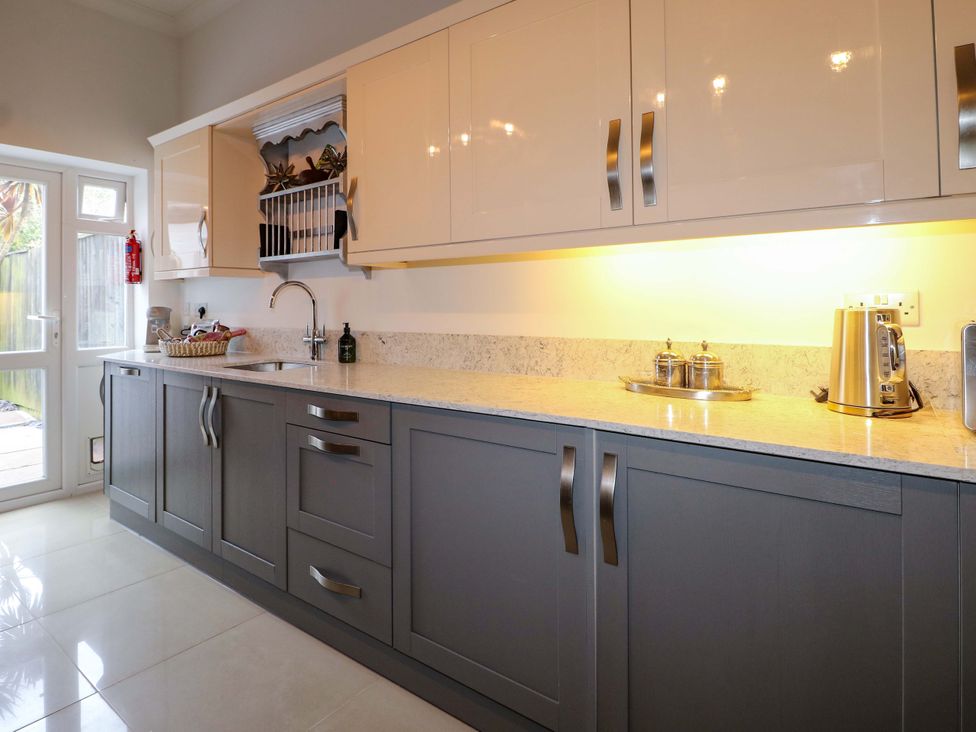 A kitchen with cabinets and a sink at The Beach House in Bournemouth