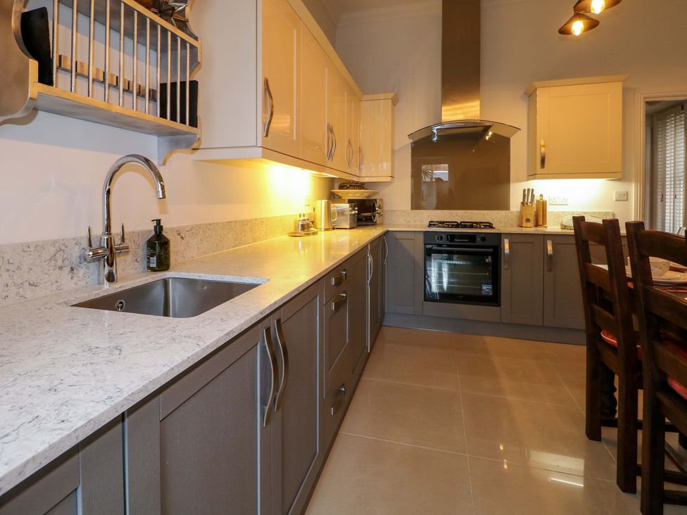 A kitchen with cabinets and appliances at The Beach House in Bournemouth