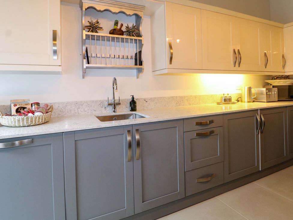 A kitchen with cabinets and a sink at The Beach House in Bournemouth