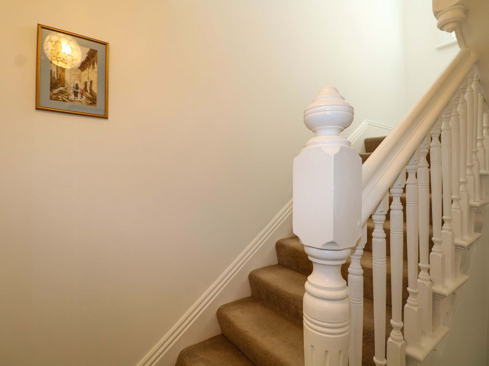 A staircase with a handrail and a painting at The Beach House in Bournemouth
