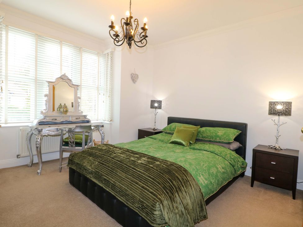 A bedroom with a bed and bedside tables at The Beach House in Bournemouth