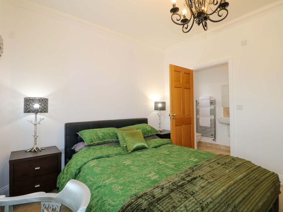 A bedroom with a bed and an en-suite bathroom at The Beach House in Bournemouth