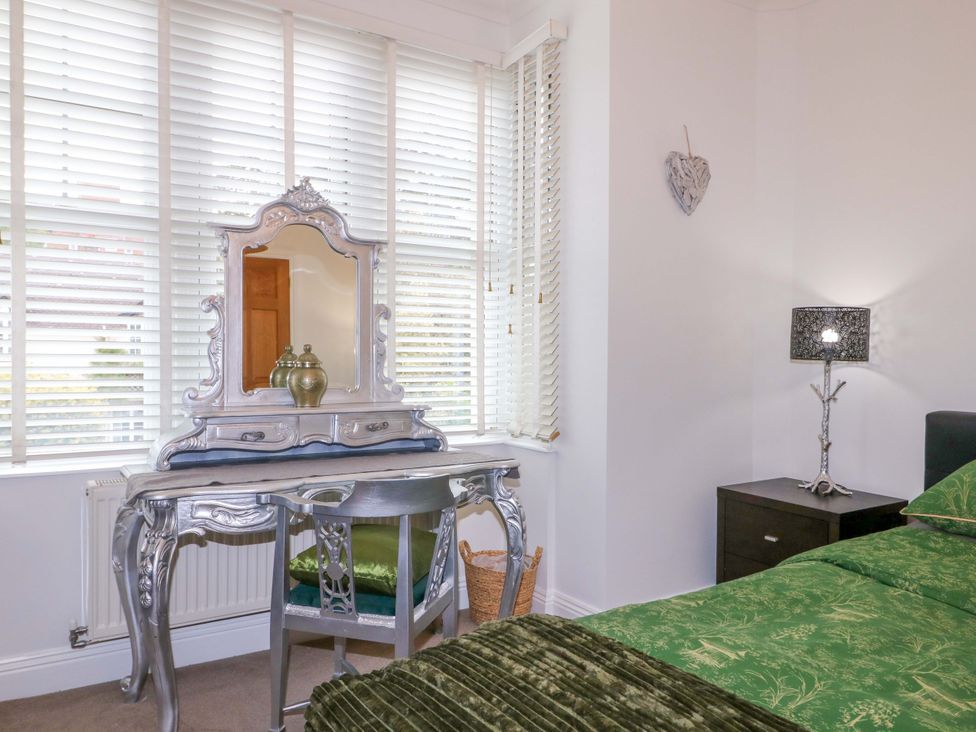 A bedroom with a dressing table and lamp at The Beach House in Bournemouth