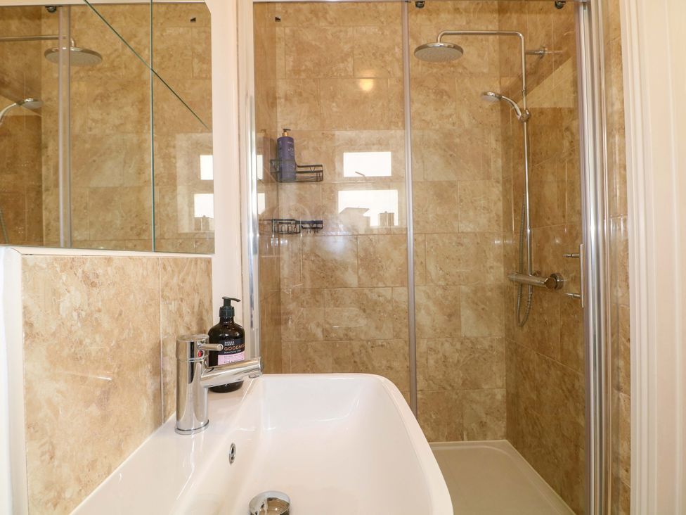 A bathroom with a shower and sink at The Beach House in Bournemouth