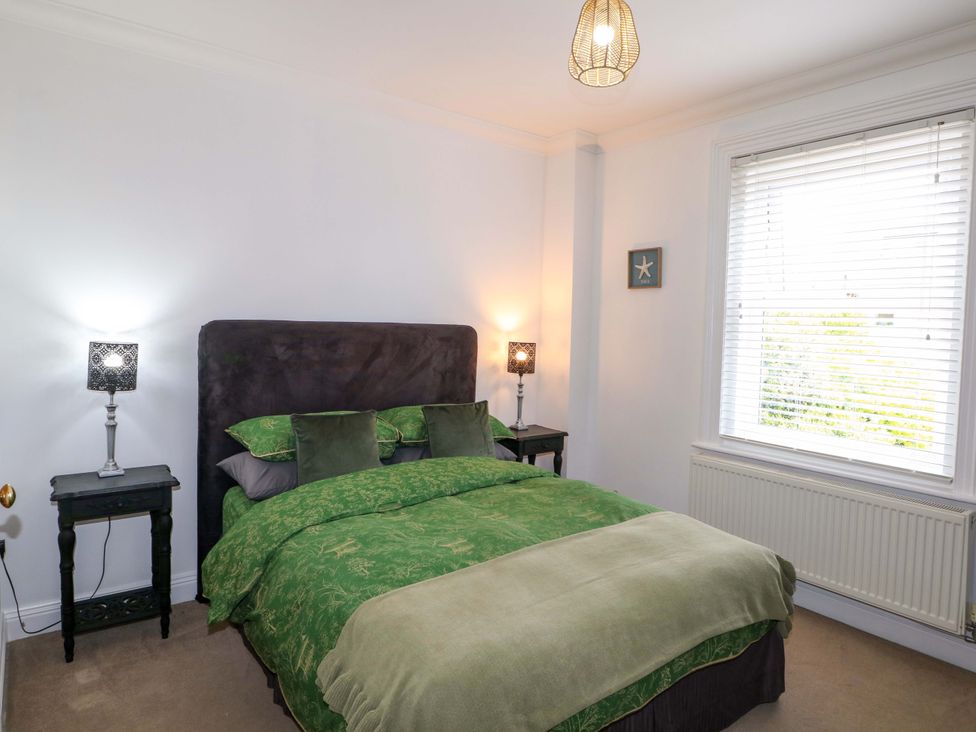 A bedroom with a bed and bedside tables at The Beach House in Bournemouth