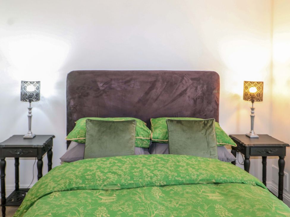 A bedroom with a bed and bedside tables at The Beach House Bournemouth