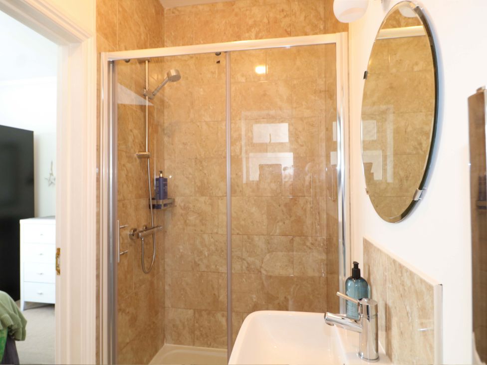 A bathroom with a shower and sink at The Beach House in Bournemouth