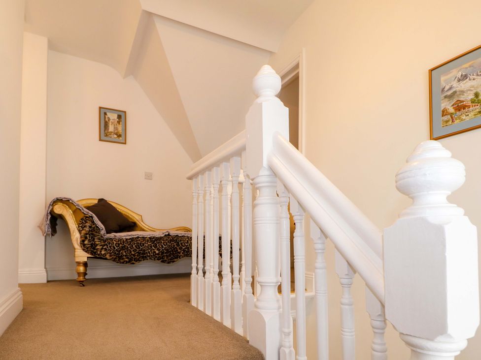 A hallway with a staircase and a sofa at The Beach House in Bournemouth