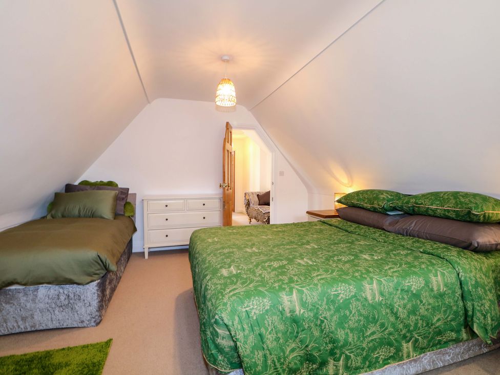 A bedroom with two beds and a dresser at The Beach House in Bournemouth