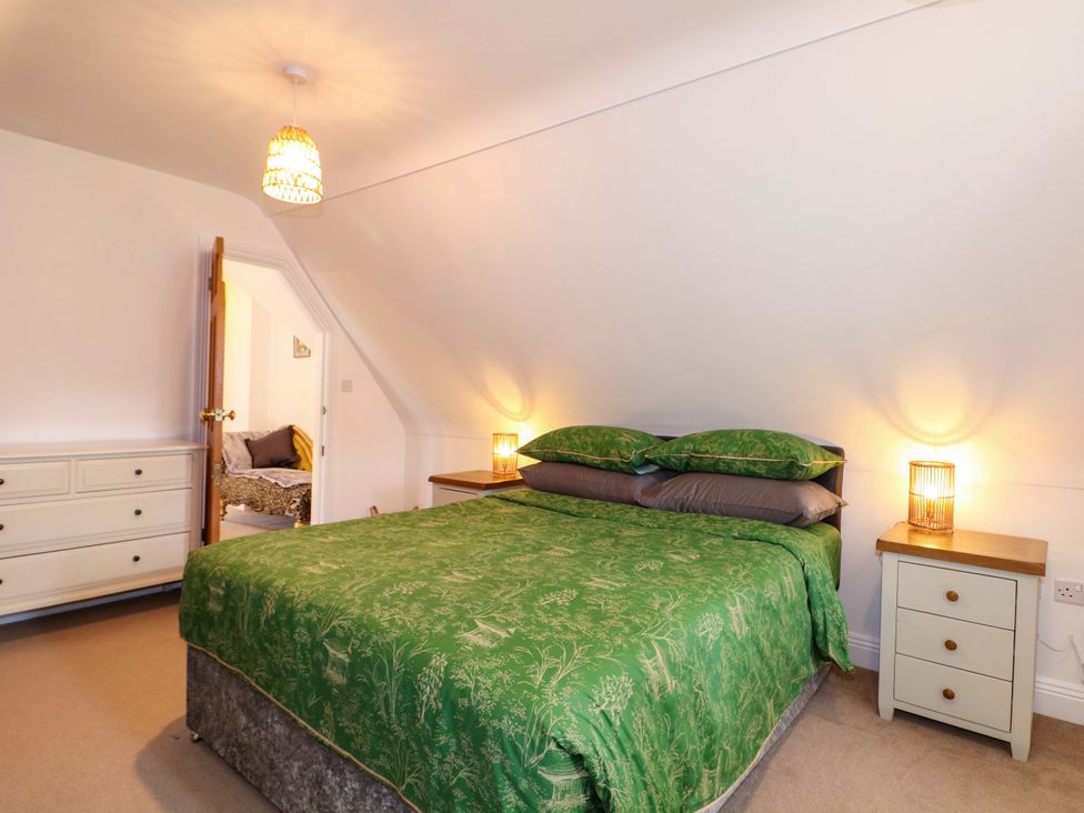 A bedroom with a bed and a bedside table at The Beach House in Bournemouth