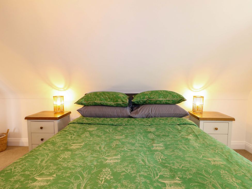 A bedroom with a bed and nightstands at The Beach House in Bournemouth