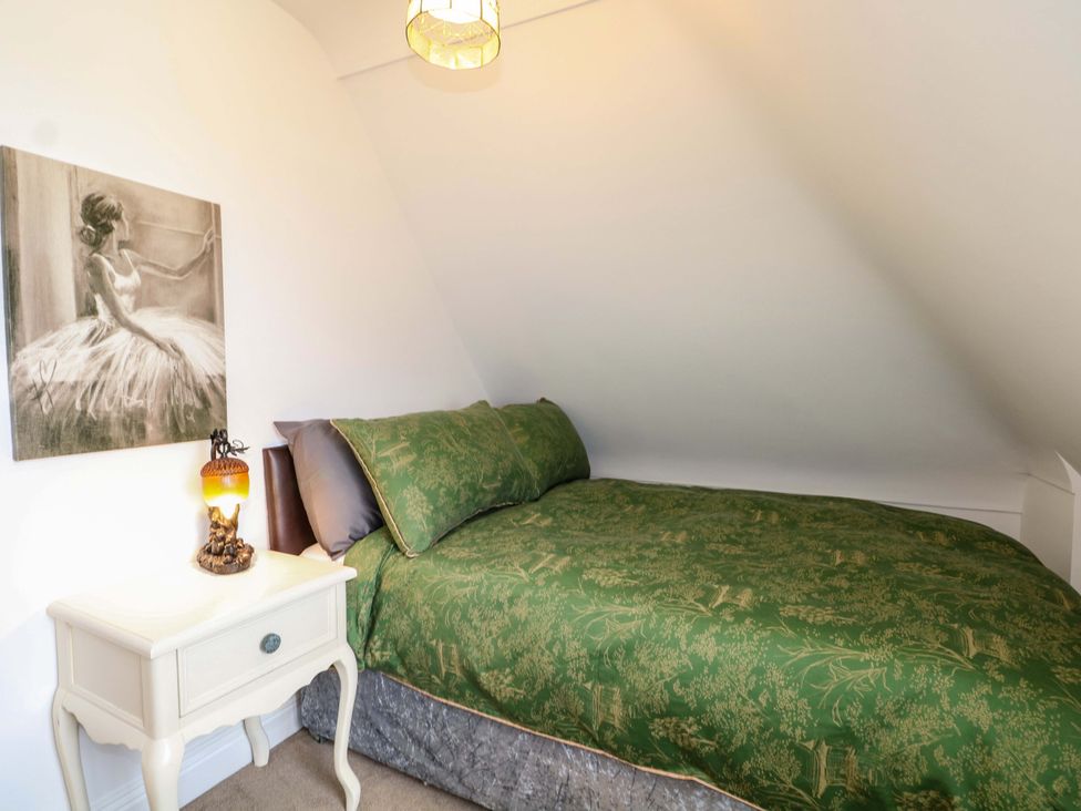 A bedroom with a bed and bedside table at The Beach House in Bournemouth