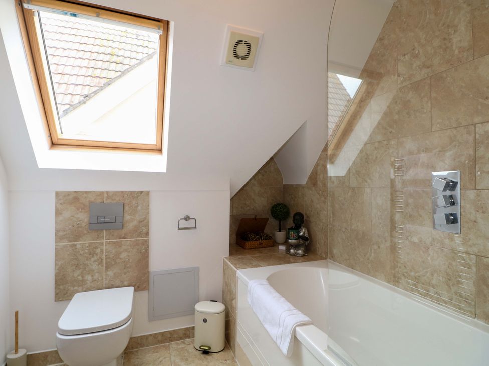 A bathroom with a window and bathtub at The Beach House in Bournemouth