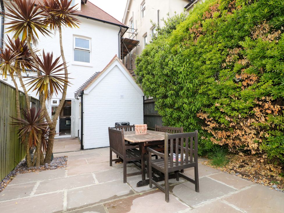 A garden with a table and chairs at The Beach House in Bournemouth