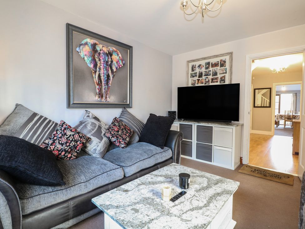 A living room with a sofa and television at Tiffanys Coach House in Bournemouth