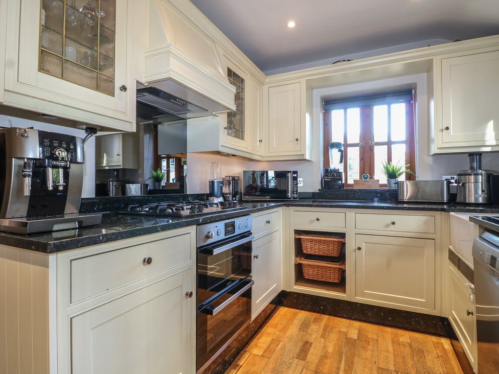 A kitchen with a coffee machine and stove at Tiffanys Coach House in Bournemouth