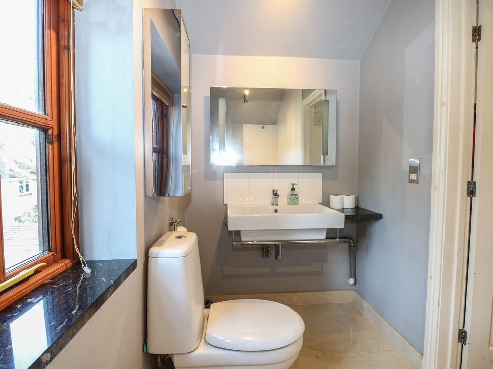 A bathroom with a toilet and sink at Tiffanys Coach House in Bournemouth